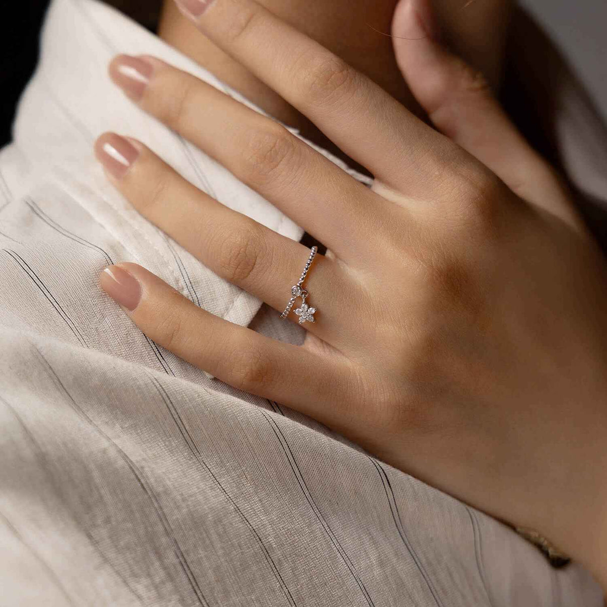 kinetic star dangle charm ring in platinum plated s925 sterling silver with caviar beaded band and paved moissanite starburst