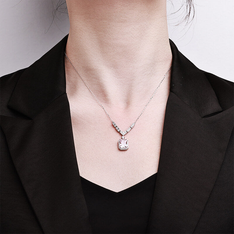 Emerald-cut pink high-carbon diamond pendant with a halo of white stones on a 925 sterling silver chain.