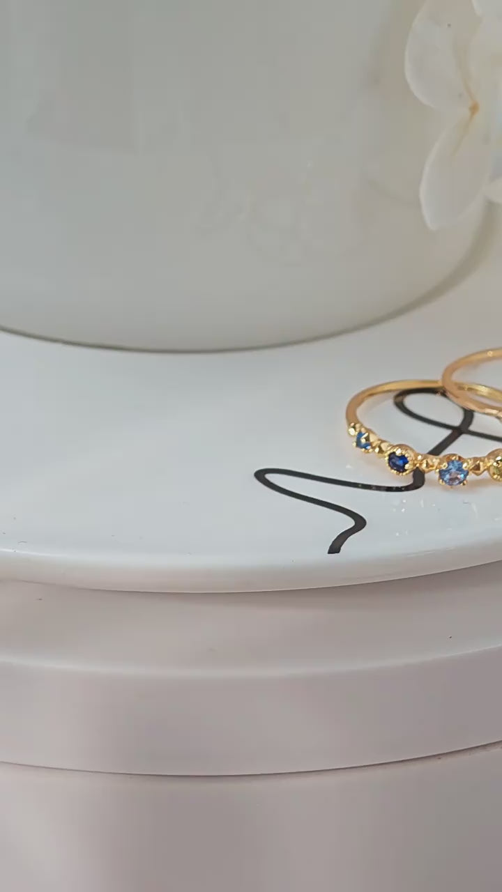 A vibrant 925 sterling silver rainbow eternity band with multi-colored stones, 14K Soft Gold plated for a pale, high-end glow.